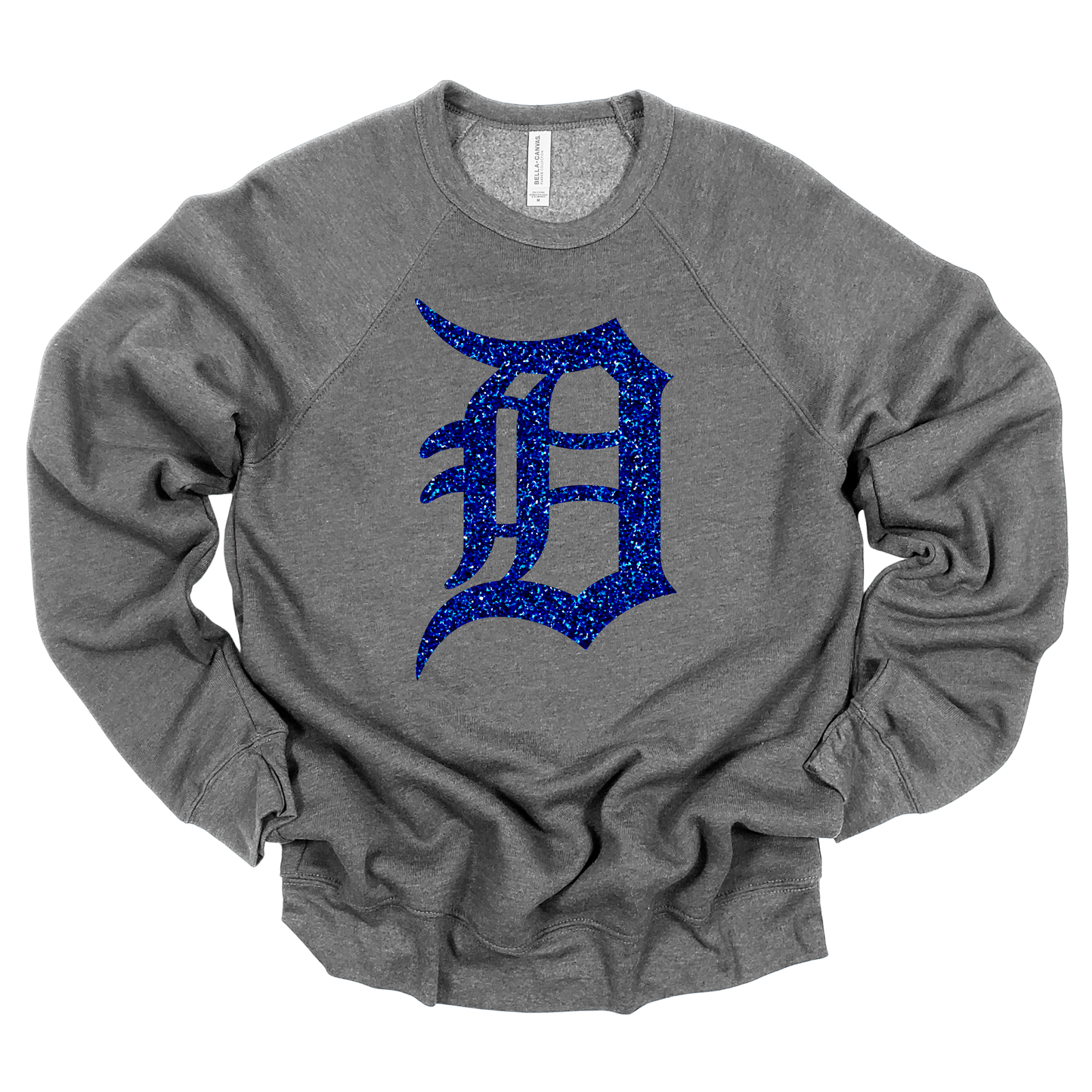 A gray crewneck sweatshirt featuring a bold, glitter-textured ‘D’ in a classic Detroit-style font. The design is shown in blue glitter, adding a sparkling touch to a sporty and stylish look.