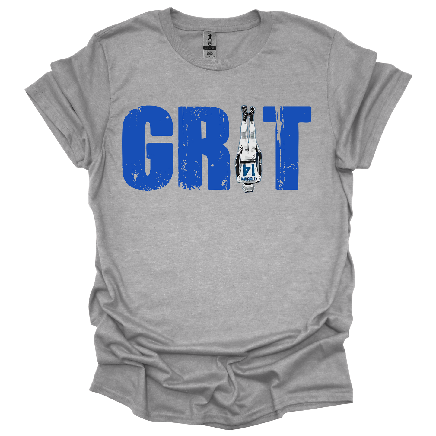 A gray T-shirt featuring the word 'GRIT' in bold, distressed blue capital letters. The letter 'I' is creatively replaced with the iconic headstand pose from Amon-Ra St. Brown wearing a white Detroit uniform, emphasizing toughness and resilience. The design has a gritty, determined feel, perfect for Detroit football fans.