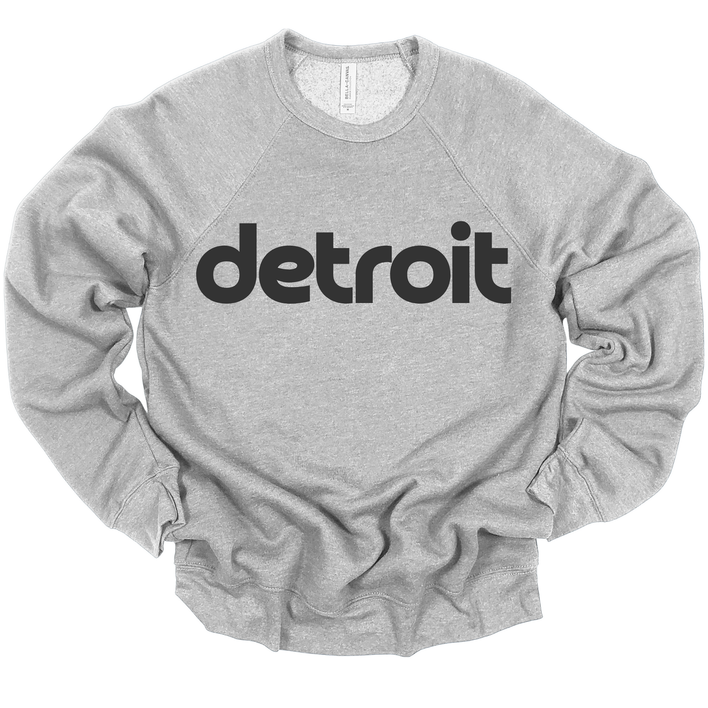 A heather gray crewneck featuring the word 'detroit' in bold, modern black lowercase lettering across the chest. The minimalist design gives a clean and stylish look, perfect for representing the Motor City in a simple yet bold way.