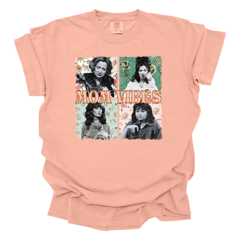 This Mom Vibes Tee is a Peach color T-shirt featuring tv mom icons Kitty Forman, Roseanne Connor, Sophia Petrillo, and Peggy Bundy each set against a retro floral background with old "mom vibes" text