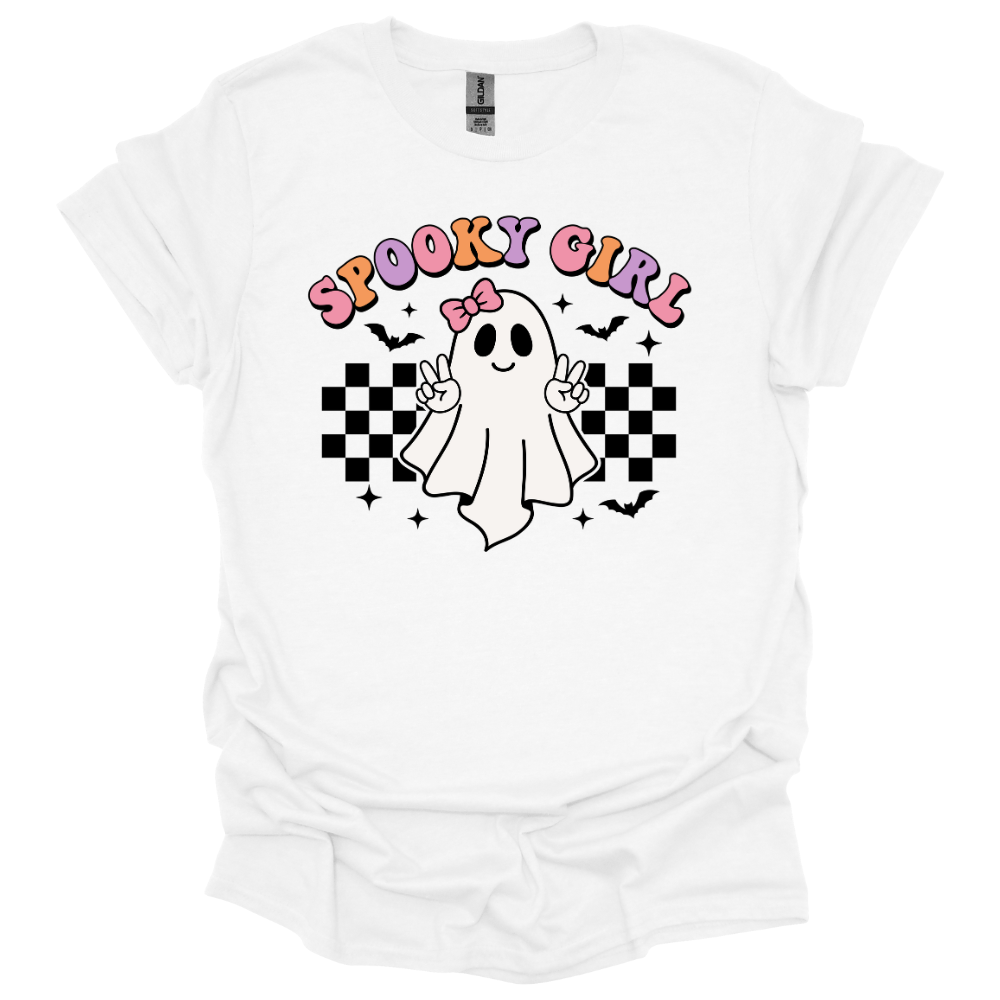 White youth Halloween shirt with a cute cartoon ghost throwing peace signs, surrounded by checkered patterns, bats, and the words “Spooky Girl” in fun pastel letters.