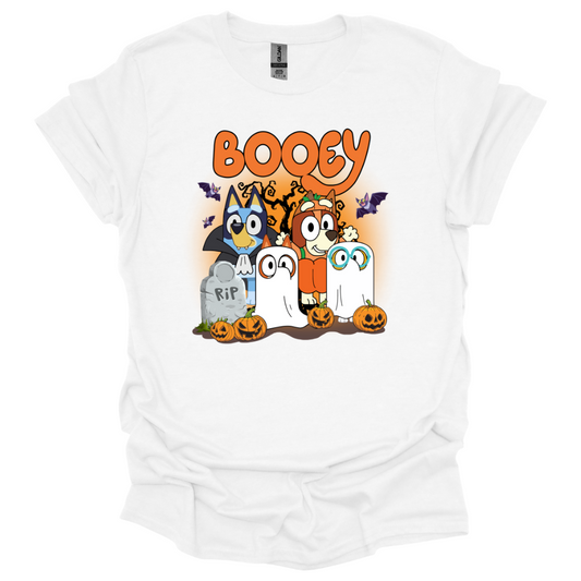 White youth t-shirt featuring Bluey-inspired characters in Halloween costumes with the word "Booey," tombstones, pumpkins, bats, and spooky trees.