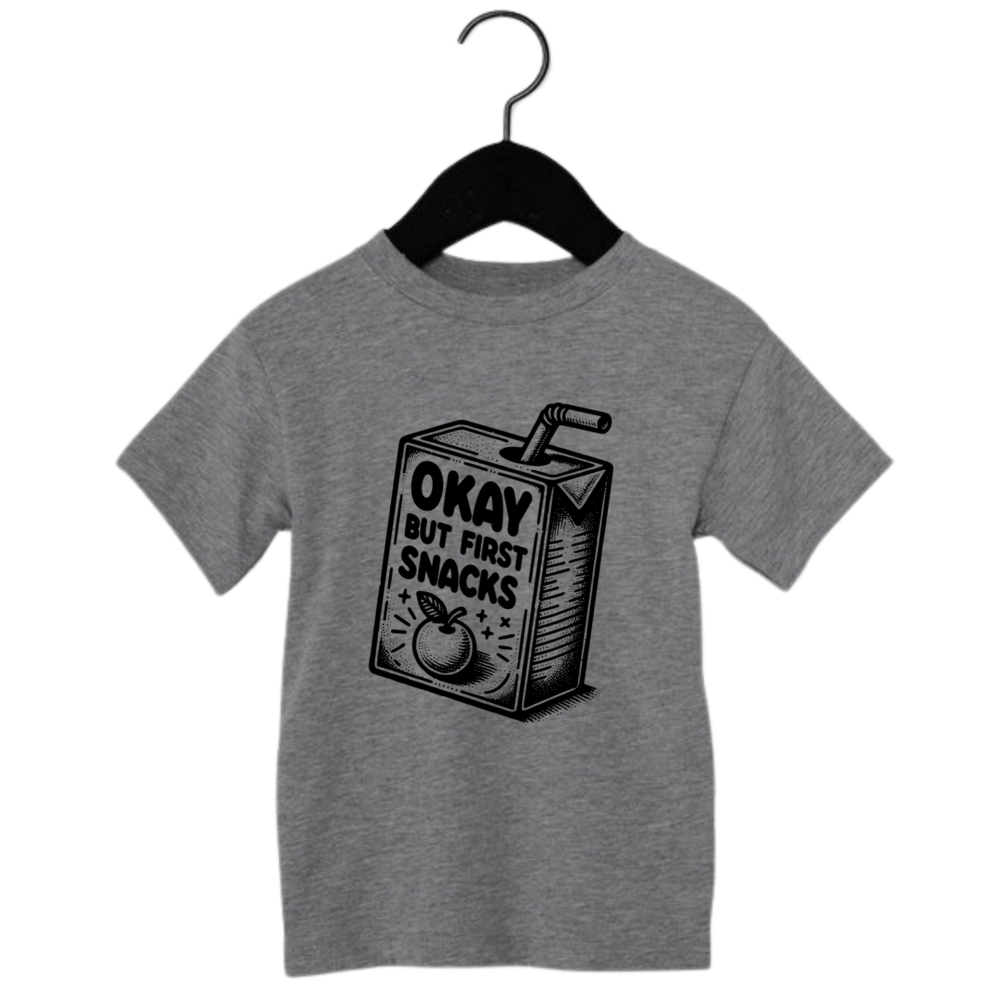 Toddler graphic tee with snack carton and the phrase ‘Okay But First Snacks’ – funny shirt for kids