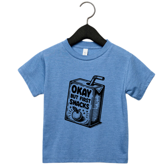 Toddler graphic tee with snack carton and the phrase ‘Okay But First Snacks’ – funny shirt for kids”
