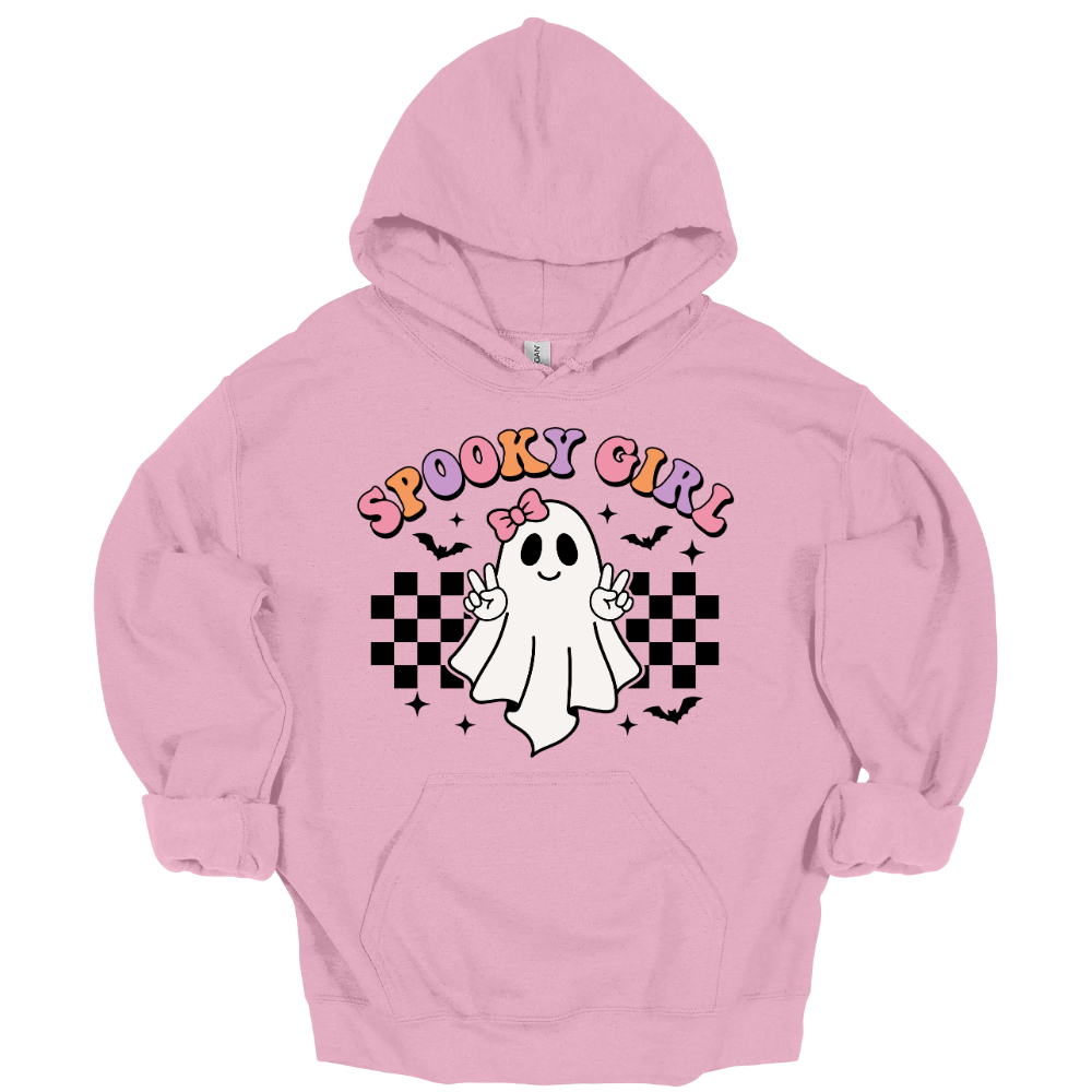 Pink youth Halloween hoodie with a cute cartoon ghost throwing peace signs, surrounded by checkered patterns, bats, and the words “Spooky Girl” in fun pastel letters.